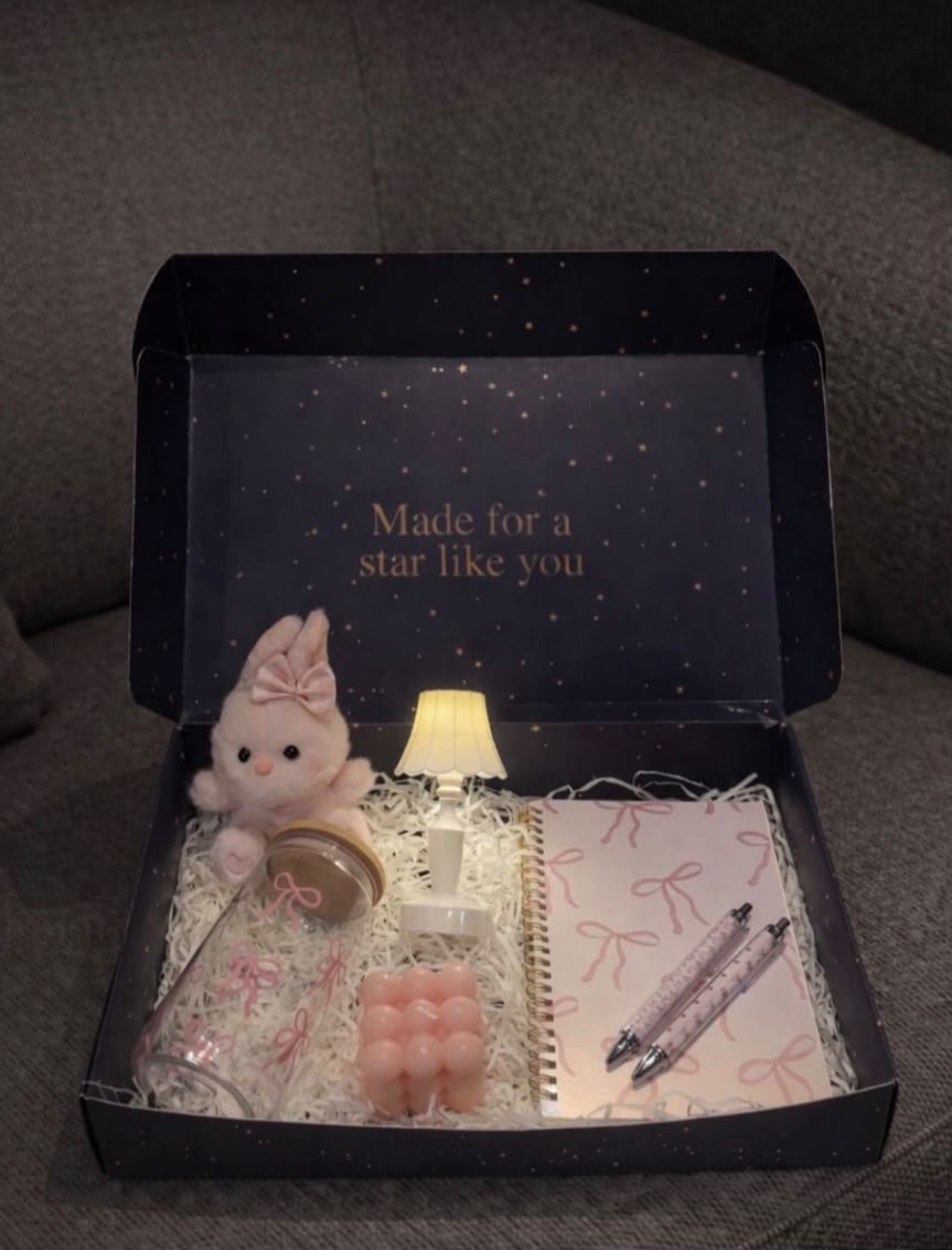 Candle + notebook + pen + lamp + bow-adorned mug + bunny plushie