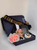 Cake + small teddy bear + crown with graduation sash + mirror + flowers